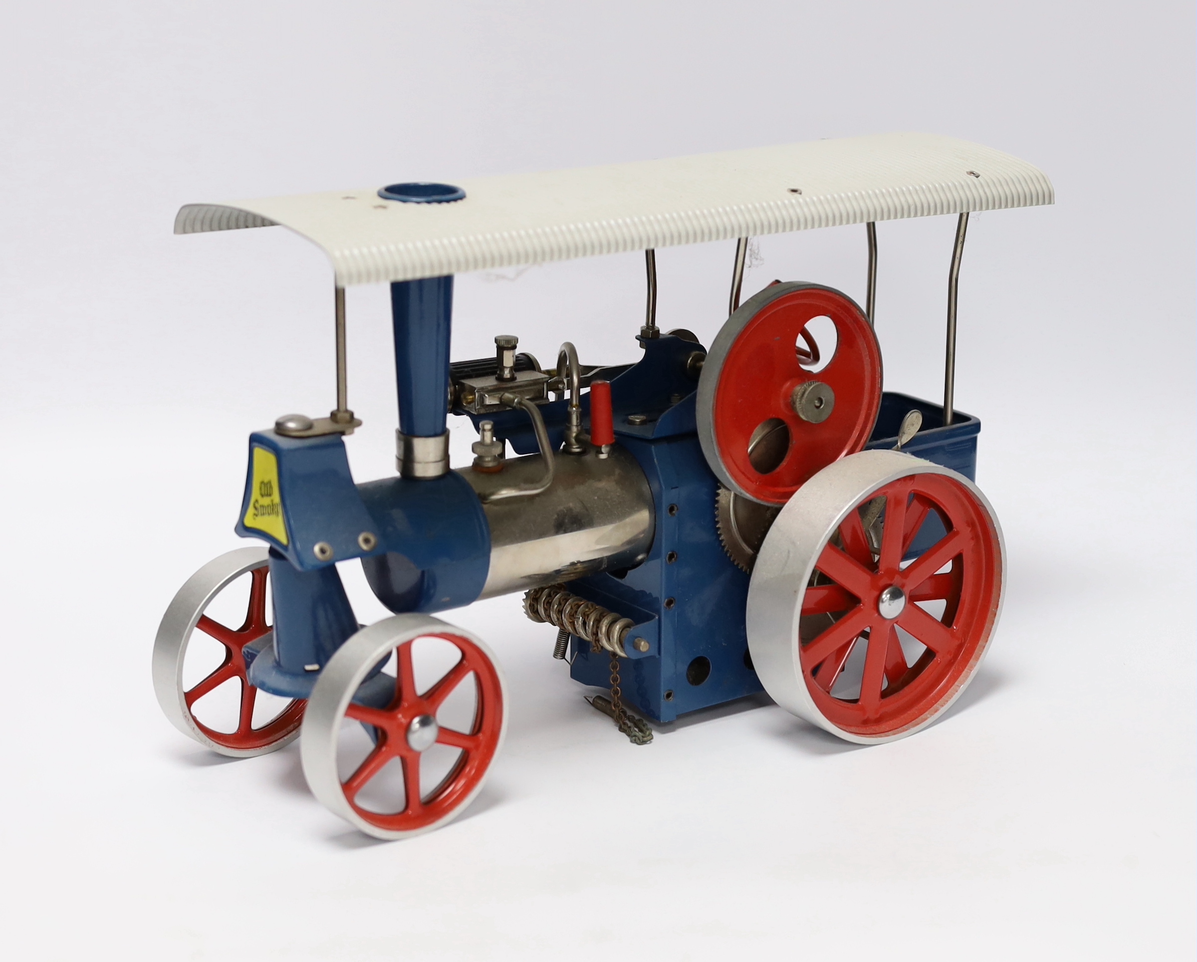 A boxed Wilesco ‘Old Smoky’ live steam traction engine (D40) and two accessories; a circular saw (M53) and a two-wheel grinder (M52), all boxed